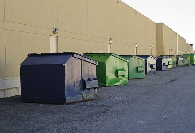 metal waste containers sit at a busy construction site in Edinburg